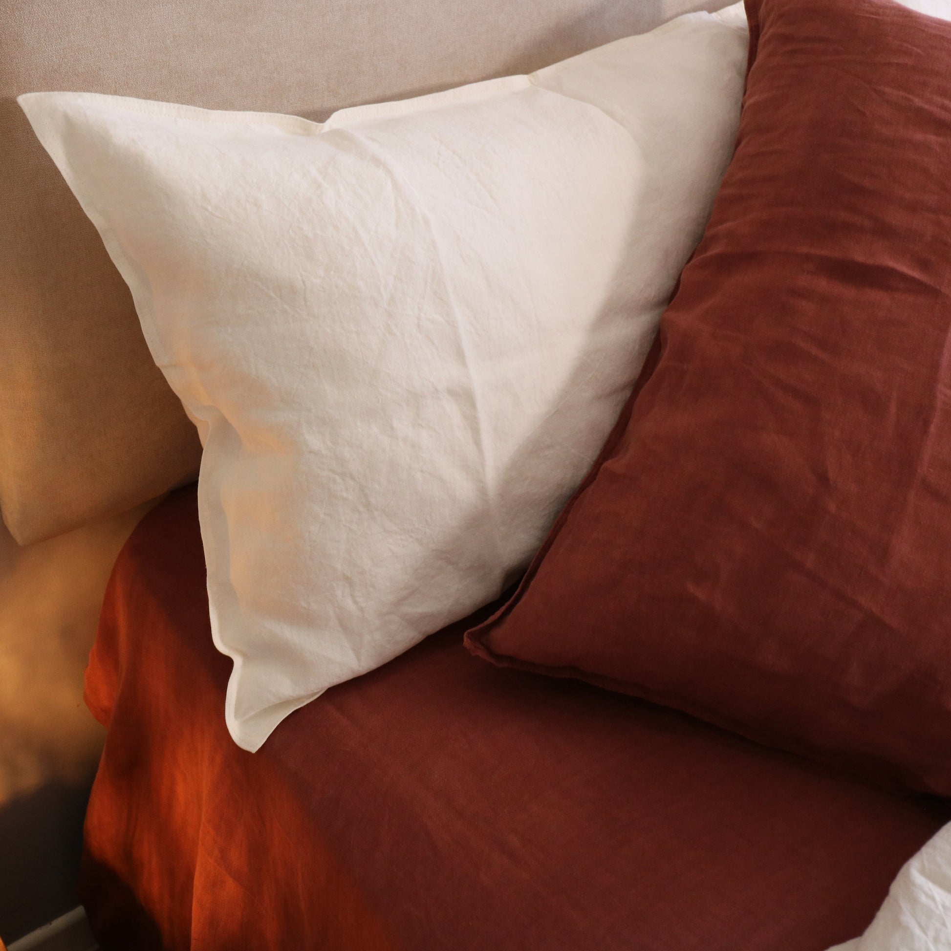 Close-up of pillows on a bed with warm lighting